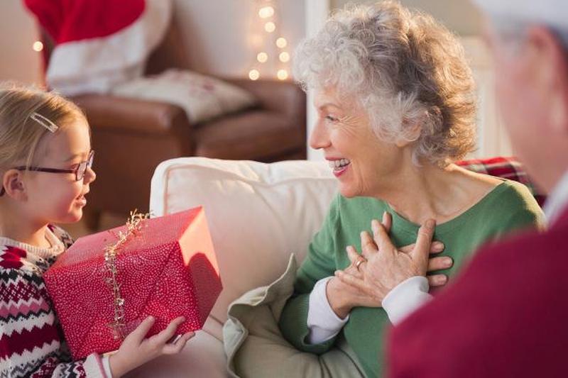 Внучка дает подарок на Рождество бабушке 